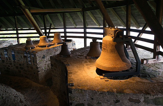Enormous bells displayed beneath a wooden roof