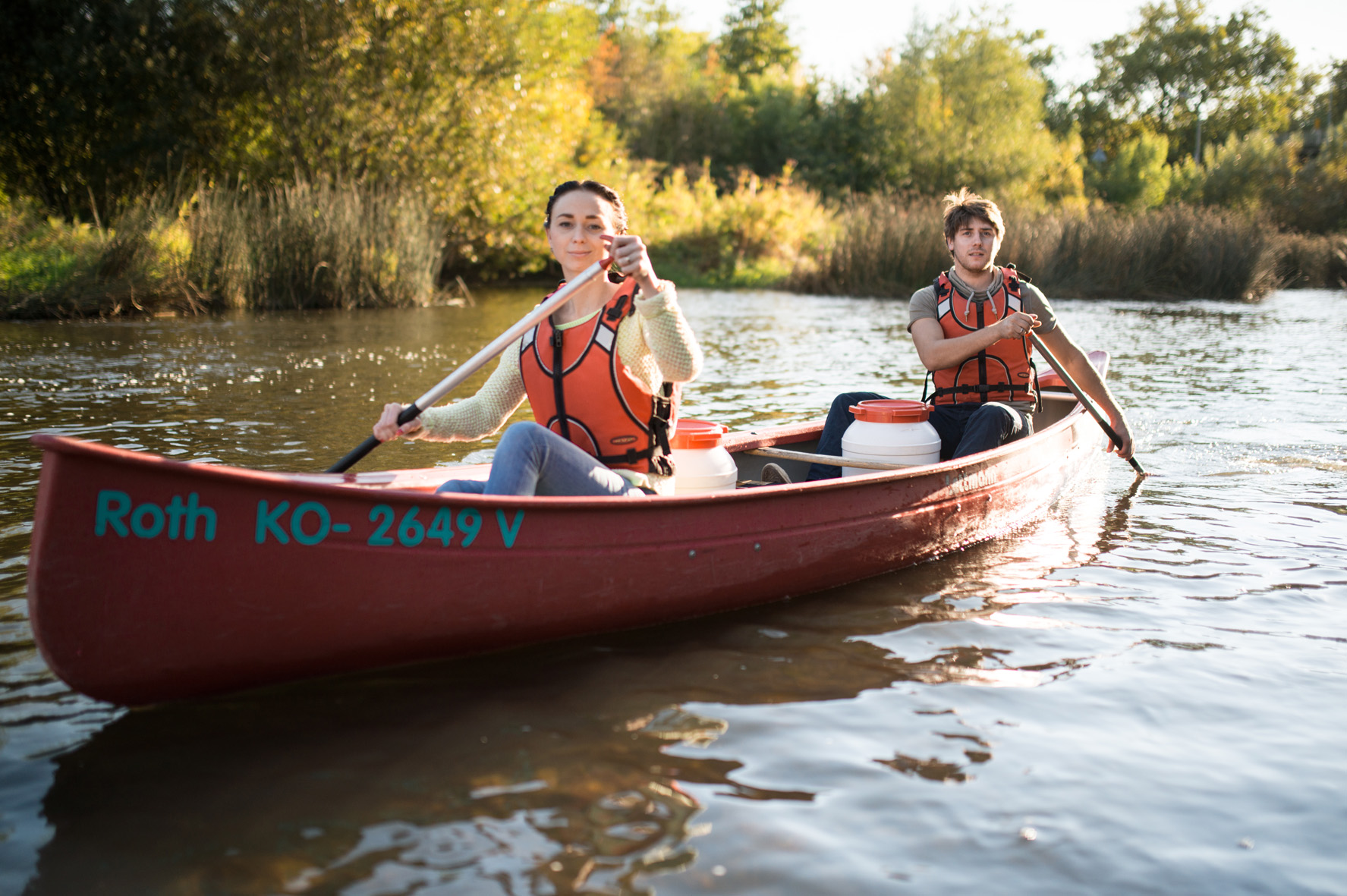 Two white people in a canoe on a river
